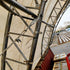 Metal scaffolding structure with a container and boxes in the background